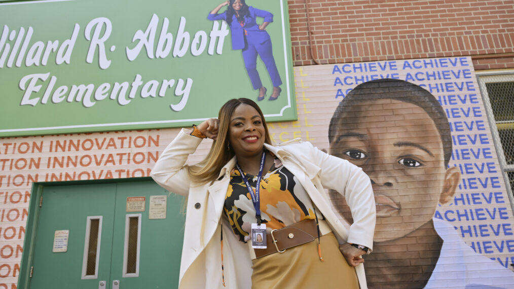 Janelle James in Abbott Elementary posing in front of exterior