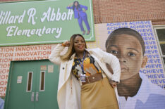 Janelle James in Abbott Elementary posing in front of exterior