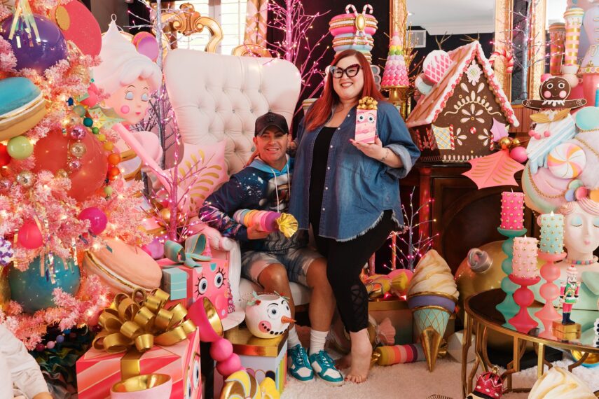 Chelsea and Bryan posing in Christmas Candyland display holding props
