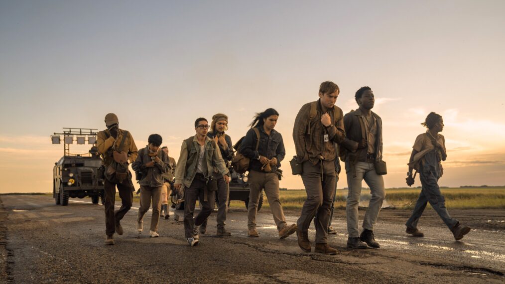 THE LONG WALK, Tut Nyuot (left), Ben Wang (left, head down), Jordan Gonzalez (eyeglasses), Charlie Plummer (headband), Joshua Odjick (long hair), Cooper Hoffman (center, hand up), David Jonsson (second from right), 2025. © Lionsgate / Courtesy Everett Collection