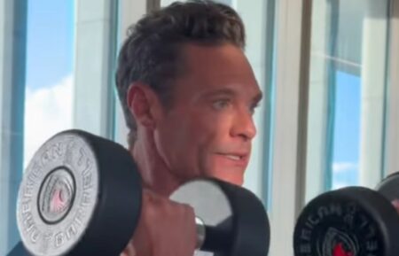 Ryan Seacrest working out, doing bicep curls