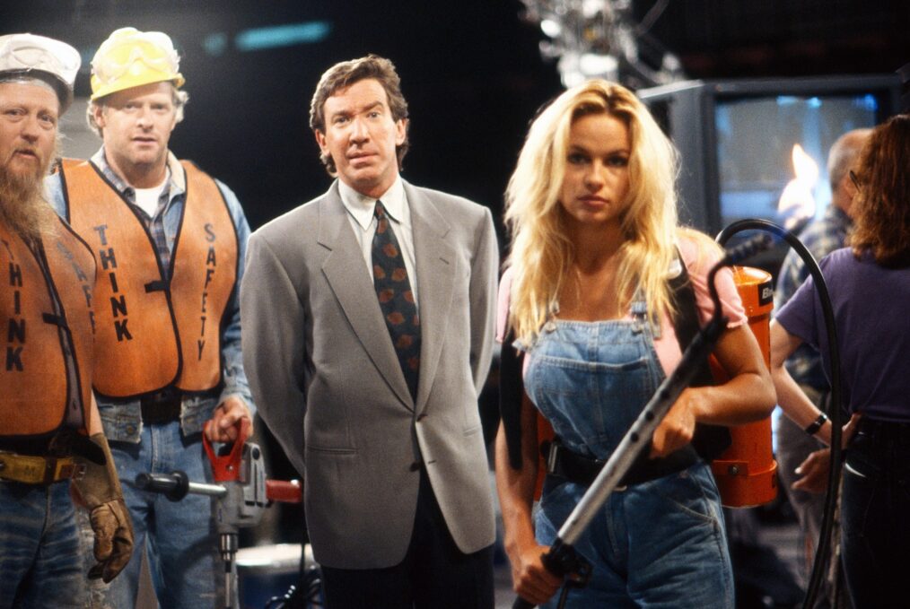 HOME IMPROVEMENT, Mickey Jones (left), Tim Allen (wearing suit), Pamela Anderson, 'Read My Hips', (Season 2 | Episode 1, aired 16 September 1992), 1991-99. ph: Randy Tepper/©Touchstone Television / Courtesy: Everett Collection