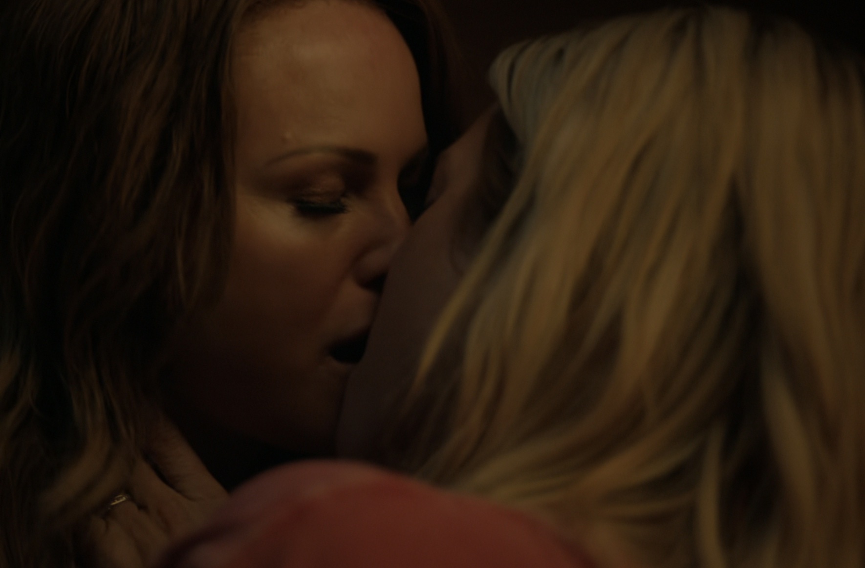 Margo and Sophie's first kiss in The Hunting Wives