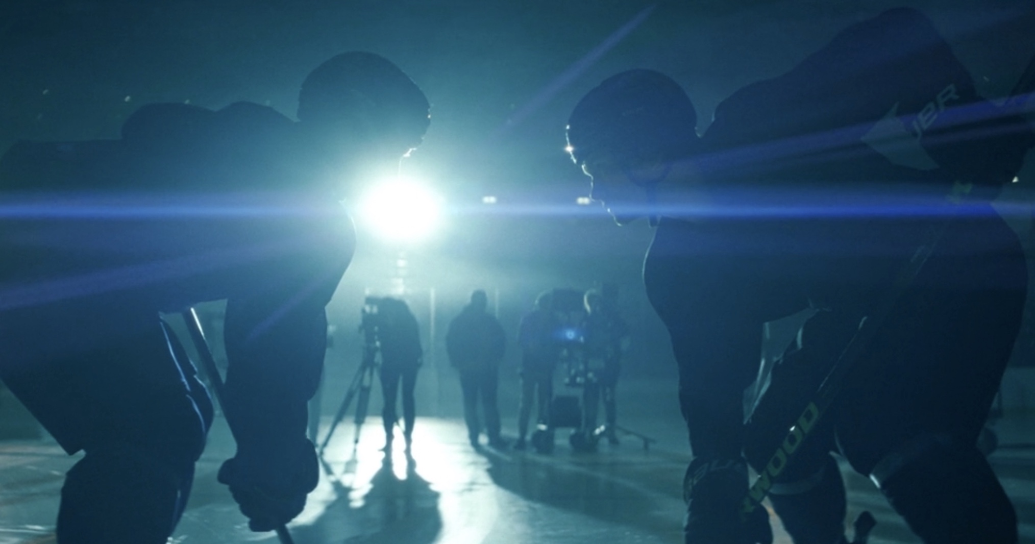 Shane and Ilya filming a commercial in 'Heated Rivalry' Season 1 episode 1