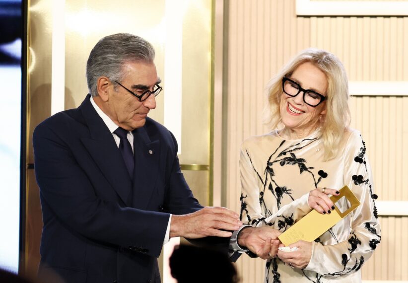 Honoree Catherine O'Hara (R) accepts the TIFF Norman Jewison Career Achievement Award from Eugene Levy (L) onstage at the TIFF Tribute Awards during the 2025 Toronto International Film Festival at The Fairmont Royal York Hotel on September 07, 2025