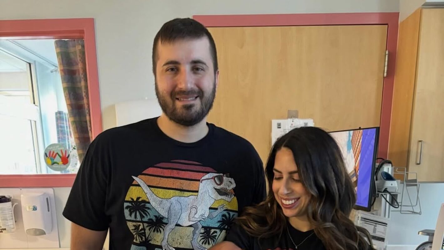Chris and Nicole Thielk with their twin babies in a hospital