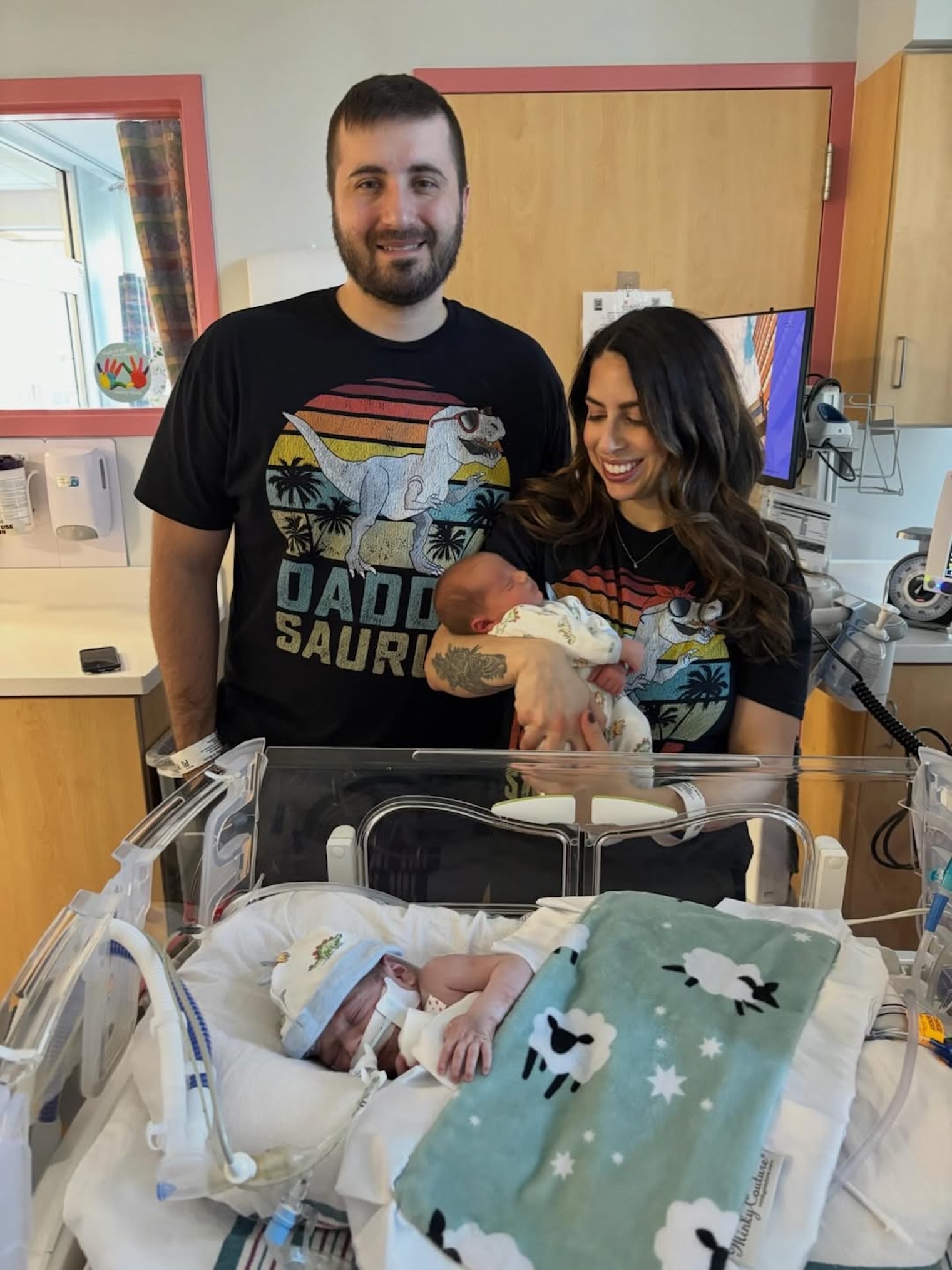 Chris and Nicole Thielk with their twin babies in a hospital