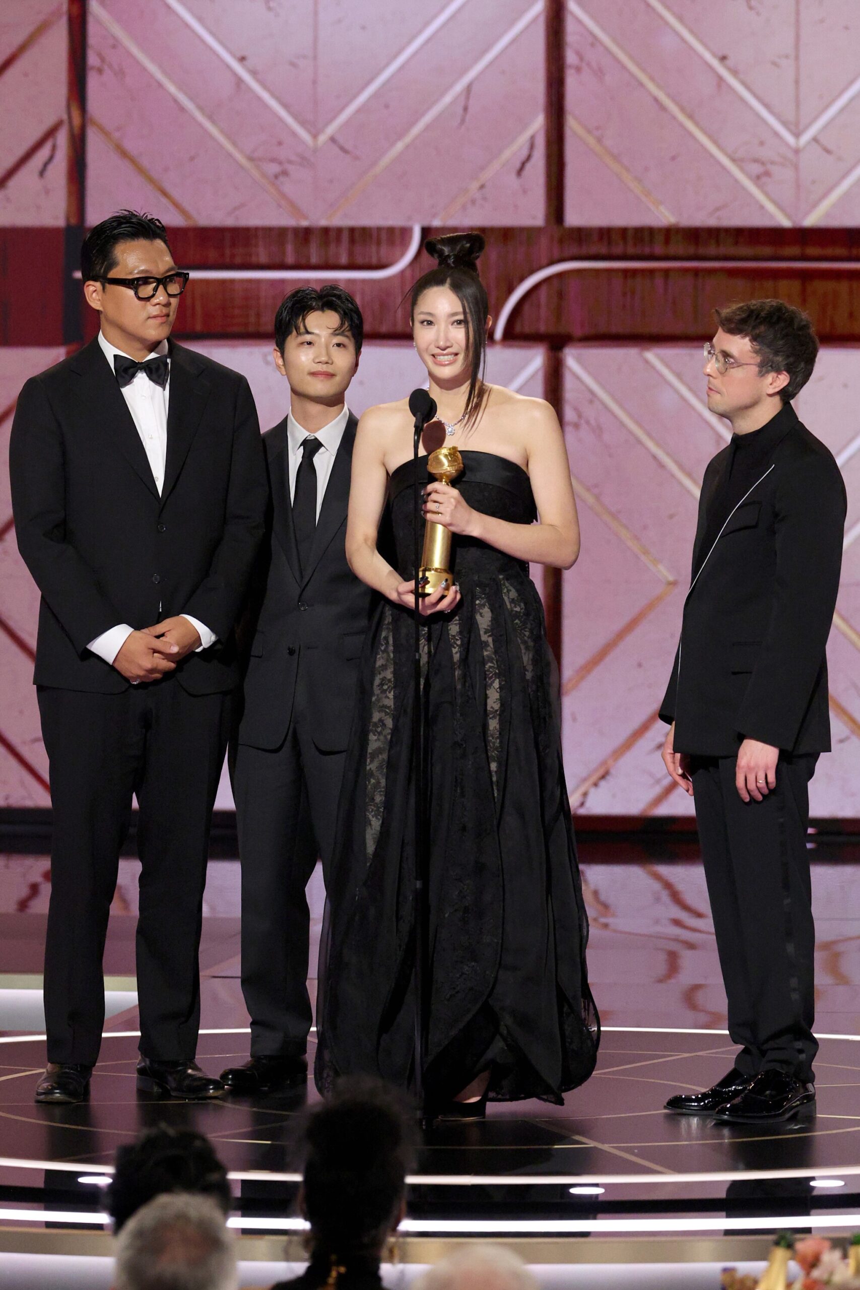 EJAE (2nd from R) accepts the Best Original Song - Motion Picture Award for 