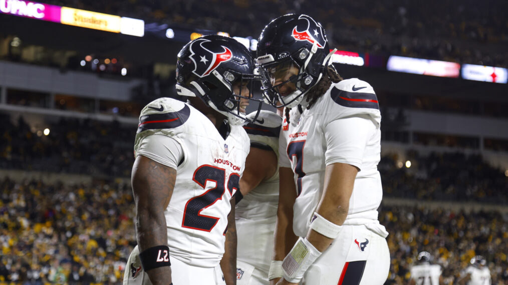 Woody Marks #27 of the Houston Texans and C.J. Stroud #7 of the Houston Texans celebrate after a rushing touchdown in the fourth quarter of an NFL wild card playoff game against the Pittsburgh Steelers at Acrisure Stadium on January 12, 2026 in Pittsburgh, Pennsylvania.