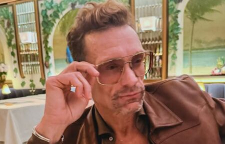 Ryan Seacrest in a brown outfit, celebrating Harry Styles' album announcement