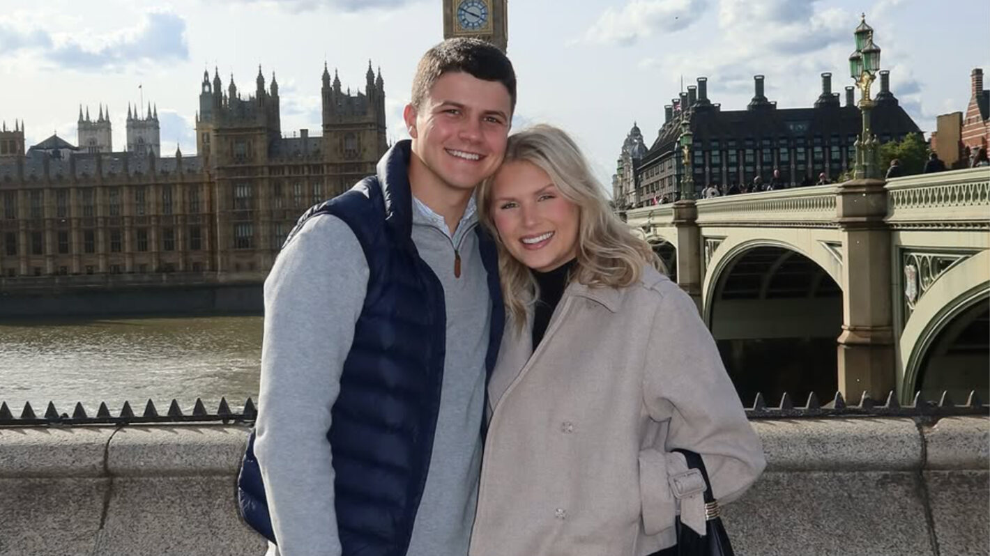 Travis Clark and Katie Bates posing in front of Big Ben in London, England