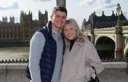 Travis Clark and Katie Bates posing in front of Big Ben in London, England