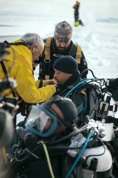Will Smith prepares to dive under the ice with Dr. Allison Fong to collect samples in the waters of the North Pole