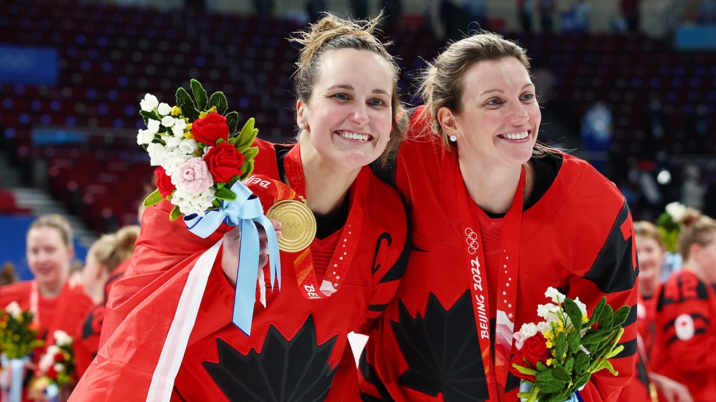 Marie-Philip Poulin #29 and Laura Stacey #7 of Team Canada celebrate during the medal ceremony after the Women's Ice Hockey Gold Medal match between Team Canada and Team United States on Day 13 of the Beijing 2022 Winter Olympic Games at Wukesong Sports Centre on February 17, 2022 in Beijing, China