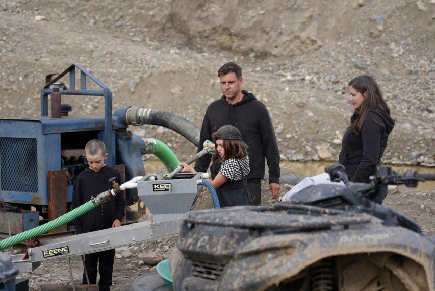 Morgan and Krissy Fraughton oversee Eva feeding mini sluice with shovel