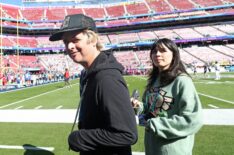 Billie Joe Armstrong (L) of Green Day looks on from the field before Super Bowl LX between the Seattle Seahawks and the New England Patriots