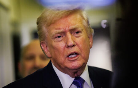 President Donald Trump gaggles with reporters while aboard Air Force One on February 6, 2026, en route to Palm Beach, Florida