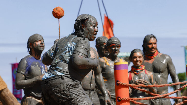 Cirie Fields competes in 'Survivor 50' premiere challenge, with Christian Hubicki, Cirie Fields, Jenna Lewis-Dougherty, Savannah Louie, and Ozzy Lusth watching behind her