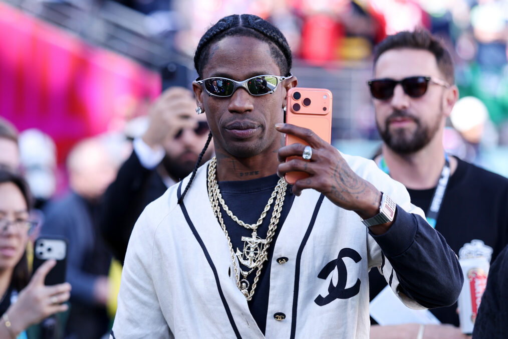 Travis Scott is seen on the sidelines prior to the start of Super Bowl LX