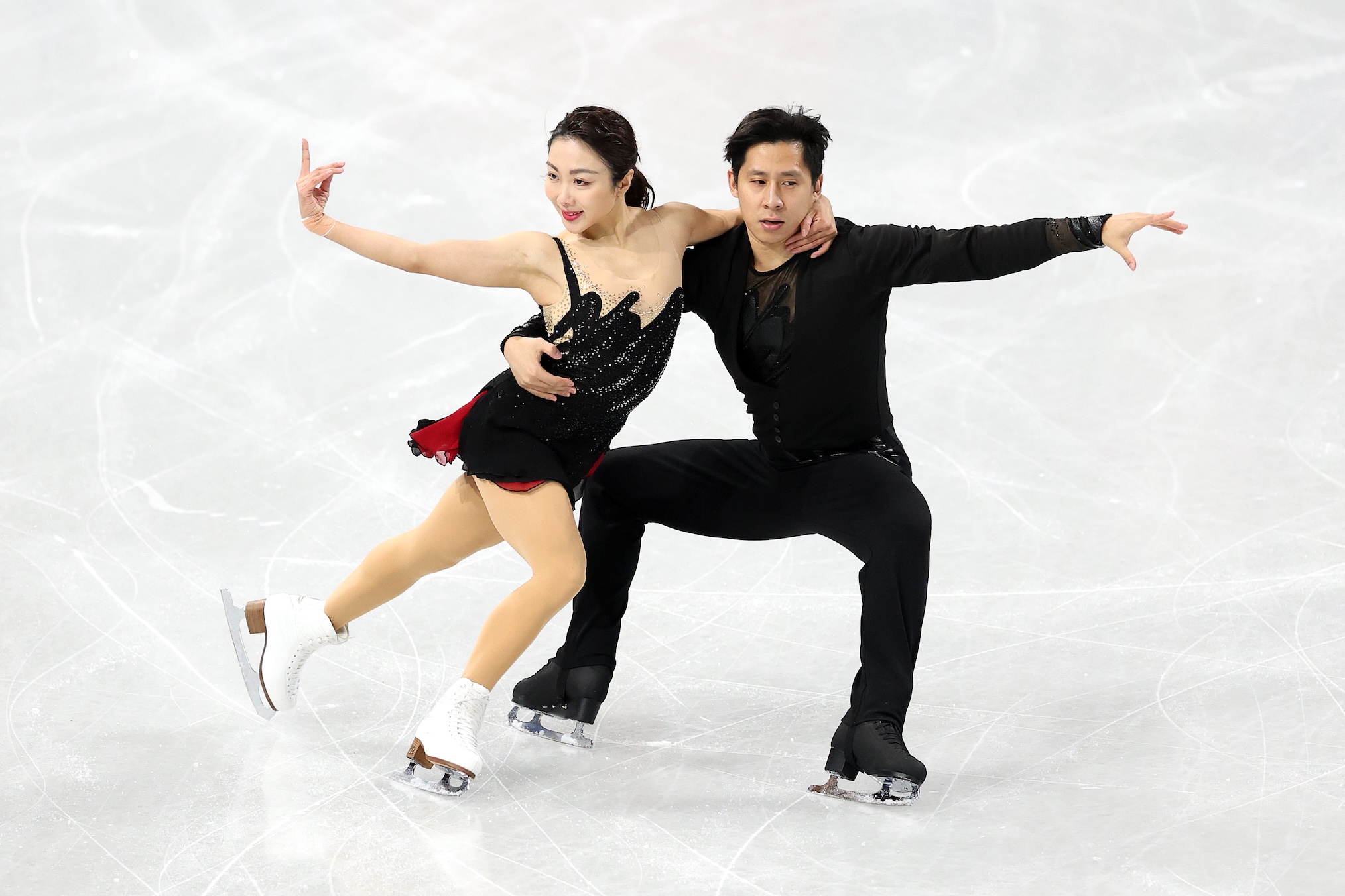 Wenjing Sui and partner Cong Han of Team People's Republic of China compete in the Pair Skating - Short Program on day zero of the Milano Cortina 2026 Winter Olympic games at Milano Ice Skating Arena on February 06, 2026 in Milan, Italy