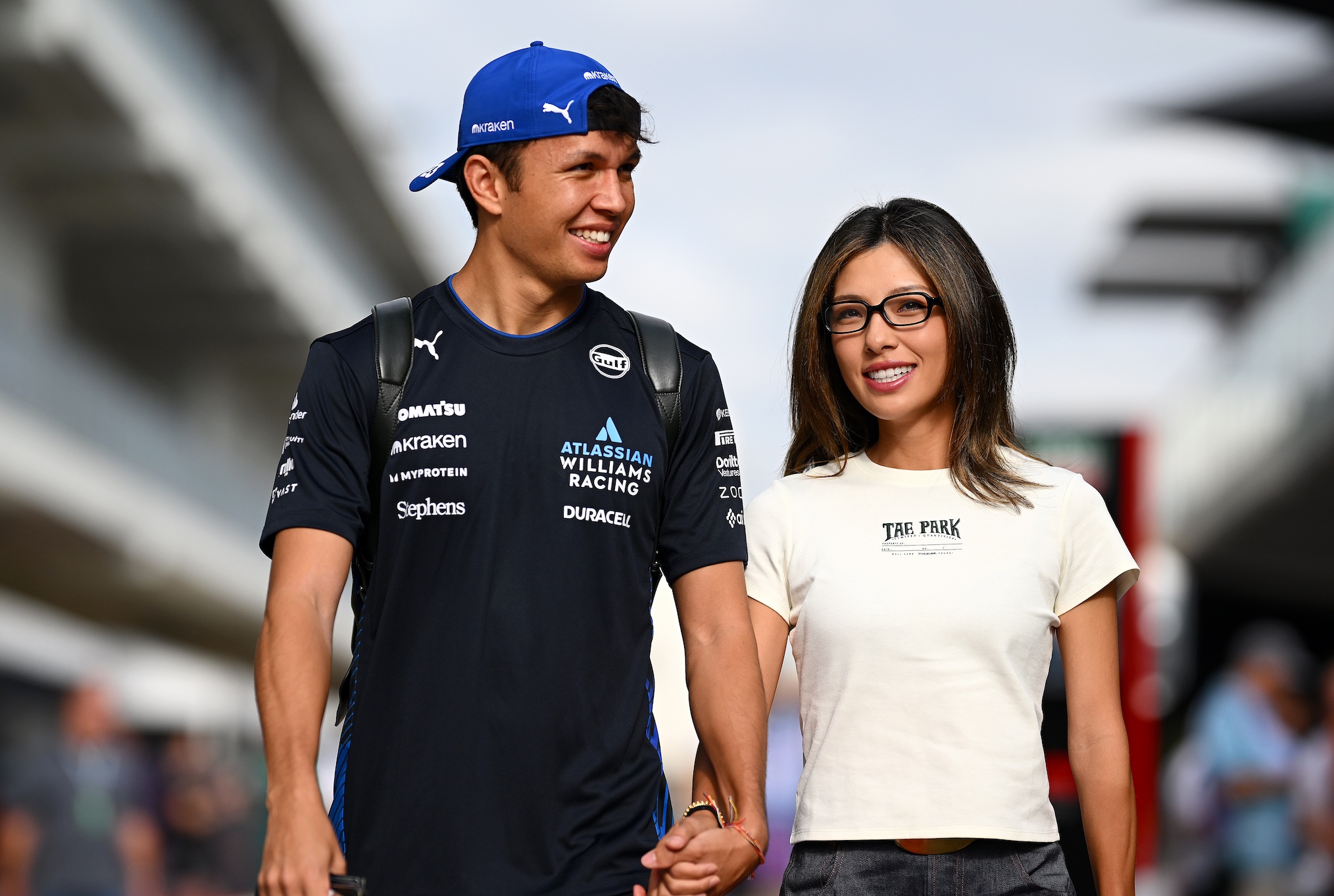 Alexander Albon of Thailand and Williams and Lily Muni He arrive in the Paddock prior to practice ahead of the F1 Grand Prix of United States at Circuit of The Americas on October 17, 2025 in Austin, Texas.