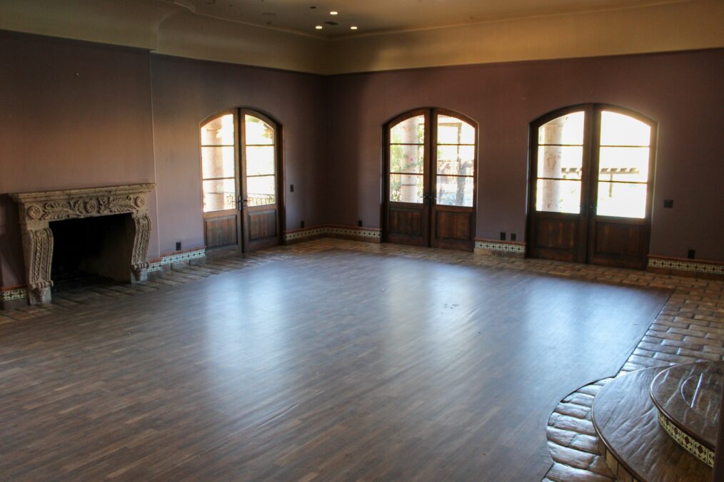 Upper angle view of empty rose room showing ceiling lights and architectural details, as seen on Bachelor Mansion Takeover, Season 1.
