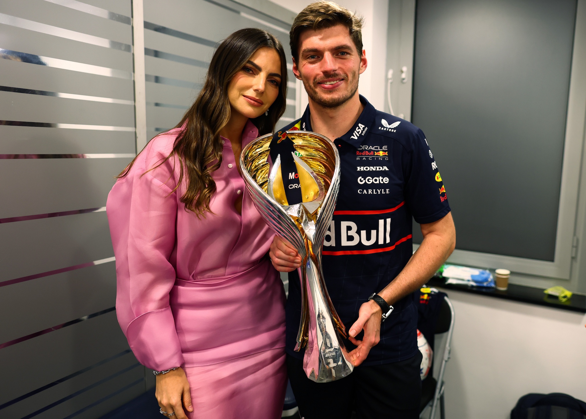 Race winner Max Verstappen of the Netherlands and Oracle Red Bull Racing and Kelly Piquet celebrate with the trophy during the F1 Grand Prix of Abu Dhabi at Yas Marina Circuit on December 07, 2025 in Abu Dhabi, United Arab Emirates.