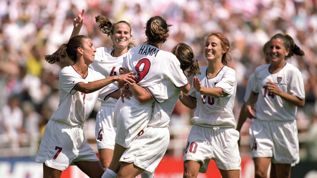 PASADENA, CA - JULY 10: Mia Hamm #9 of Team USA is embraced by Shannon MacMillan #8 as teammates Joy Fawcett #14, Kate Sobrero #20, Carla Overbeck #4 and Sara Whalen #7 celebrate the victory over Team China in the Final match of the FIFA Women's World Cup at the Rose Bowl on July 10, 1999 in Pasadena, California. Team USA defeated Team China 5-4 in sudden death after two overtimes. (Photo by Jed Jacobsohn/Getty Images)