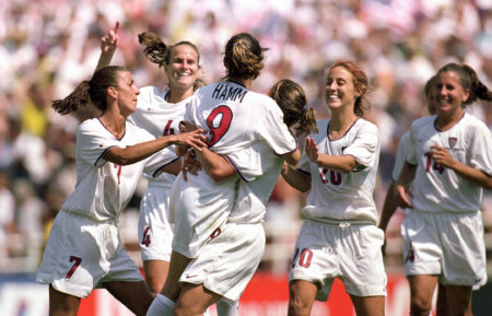 PASADENA, CA - JULY 10: Mia Hamm #9 of Team USA is embraced by Shannon MacMillan #8 as teammates Joy Fawcett #14, Kate Sobrero #20, Carla Overbeck #4 and Sara Whalen #7 celebrate the victory over Team China in the Final match of the FIFA Women's World Cup at the Rose Bowl on July 10, 1999 in Pasadena, California. Team USA defeated Team China 5-4 in sudden death after two overtimes. (Photo by Jed Jacobsohn/Getty Images)