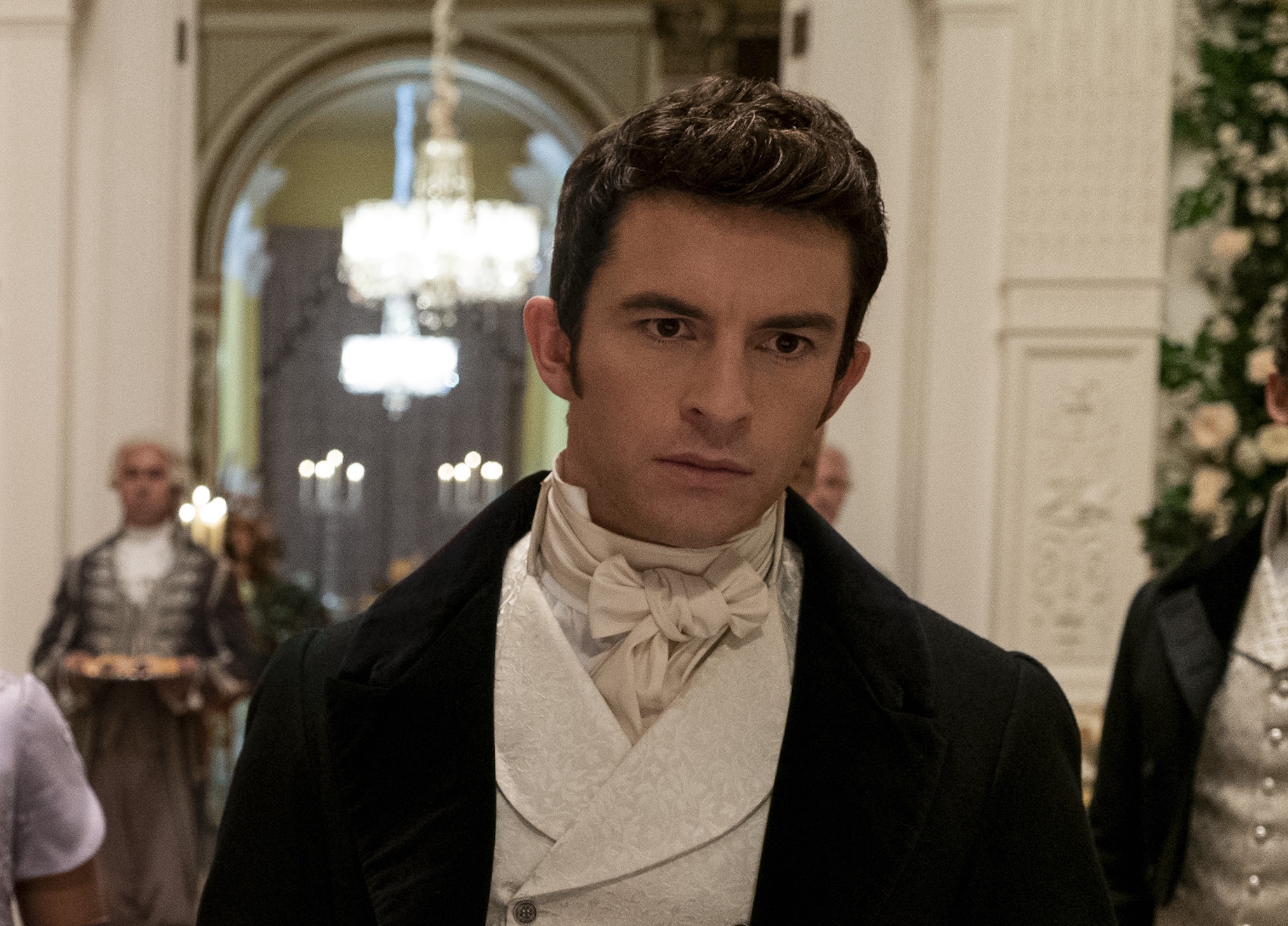 Charithra Chandran as Edwina Sharma, Simone Ashley as Kate Sharma, Shelley Conn as Mary Sharma, Jonathan Bailey as Anthony Bridgerton in episode 207 of Bridgerton.