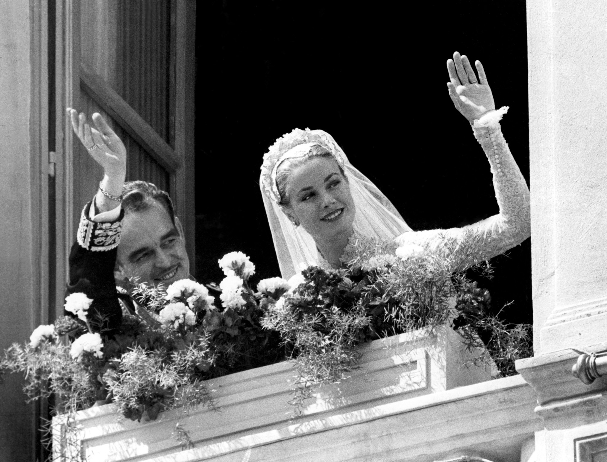 Prince Rainier, Princess Grace Kelly waving from the Monaco Royal Palace after their wedding in 1956