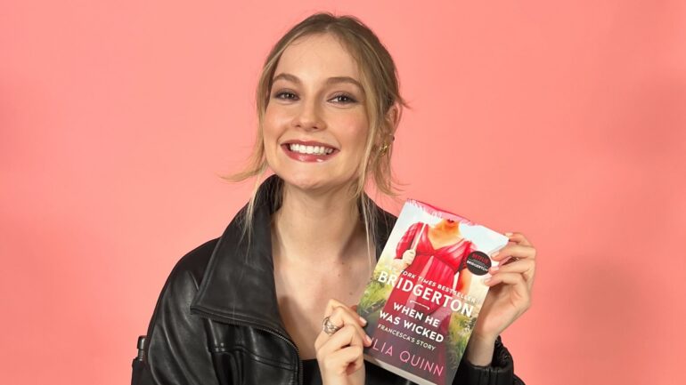 Hannah Dodd holding the book 'When He Was Wicked' by Julia Quinn