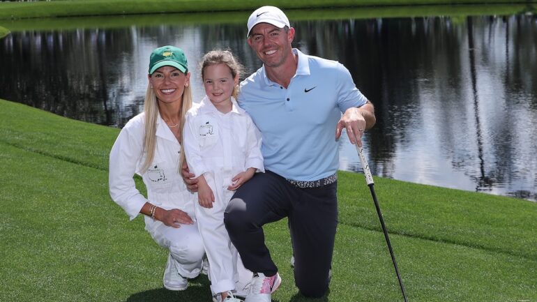 Erica Stoll, Poppy McIlroy, and Rory McIlroy of Northern Ireland pose for a photo on the fifth hole during the Par Three Contest prior to the 2025 Masters Tournament at Augusta National Golf Club on April 09, 2025 in Augusta, Georgia.