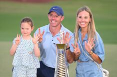Rory McIlroy of Northern Ireland poses with his Daughter, Poppy and Wife, Erica, holding 7 fingers to the camera, alongside the Race to Dubai trophy on the 18th green on day four of the DP World Tour Championship 2025 at Jumeirah Golf Estates on November 16, 2025 in Dubai, United Arab Emirates.