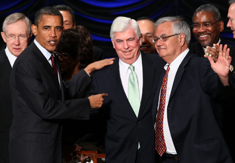 U.S. President Barack Obama greets Rep. Barney Frank (R) (D-MA) and Sen. Chris Dodd (C) (D-CT) after signing the Dodd-Frank Wall Street Reform and Consumer Protection Act
