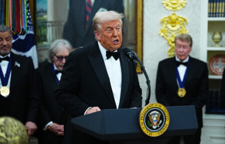 WASHINGTON, DC - DECEMBER 06: U.S. President Donald Trump delivers remarks as honorees (L-R) actor Sylvester Stallone, musician Peter Criss of the rock band KISS and actor Michael Crawford look on during the medal presentation ceremony for the 2025 Kennedy Center Honorees in the Oval Office of the White House on December 06, 2025 in Washington, DC. The 2025 Kennedy Center honorees are Sylvester Stallone, George Strait, the rock band KISS, Gloria Gaynor, and Michael Crawford. (Photo by Aaron Schwartz/Getty Images)