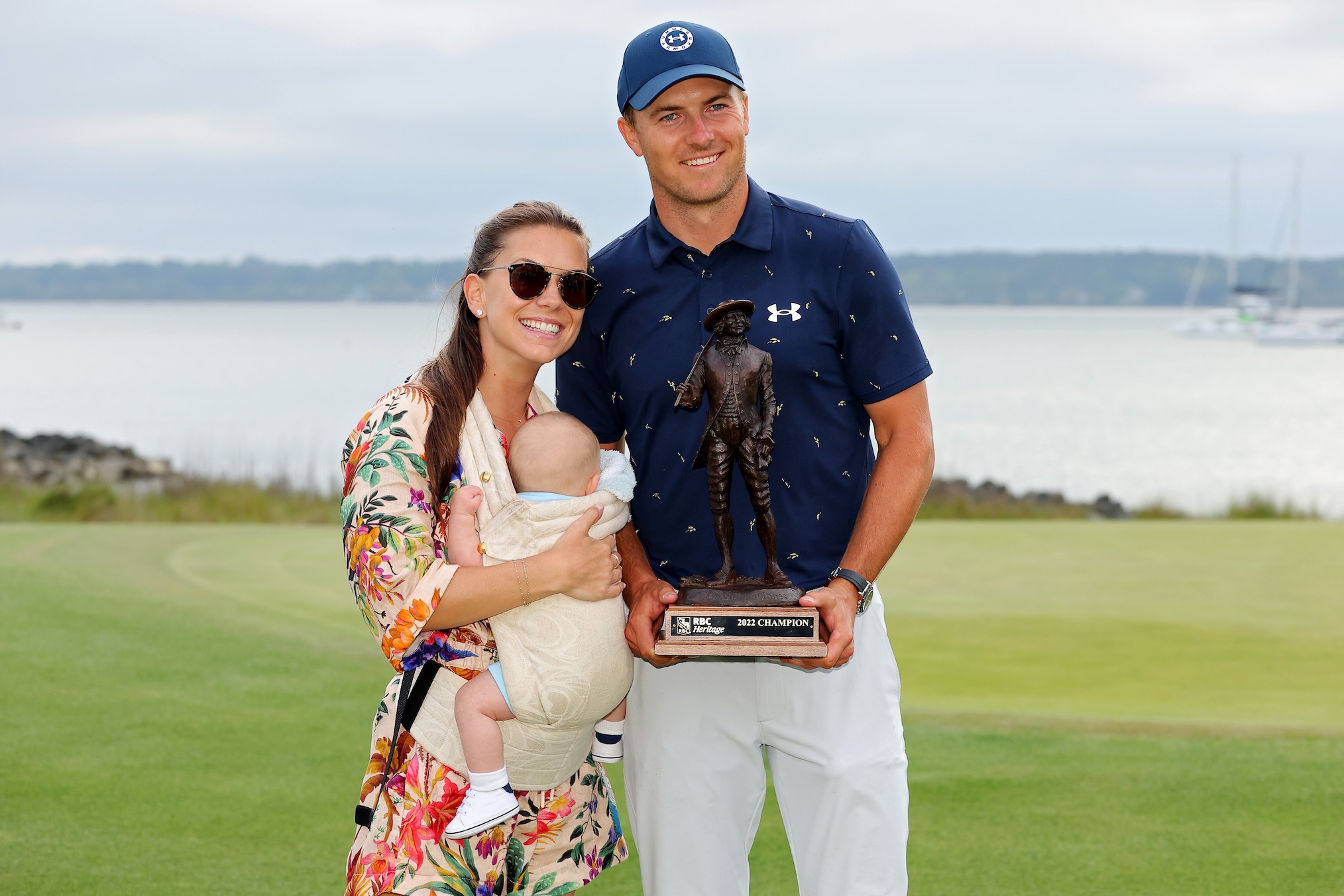 Jordan Spieth poses with the trophy with wife Annie Verret and son Sammy Spieth after winning the RBC Heritage in a playoff at Harbor Town Golf Links on April 17, 2022 in Hilton Head Island, South Carolina.