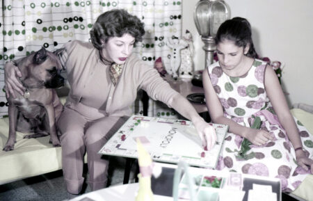 Martha Raye, playing Monopoly at home with her daughter, Melodye Condos, ca. early 1960s