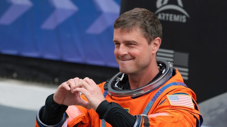 Commander Reid Wiseman makes a heart with his hands as he walks out of the Neil A. Armstrong Operations and Checkout Building ahead of the launch of the Artemis II at NASA’s Kennedy Space Center on April 01, 2026 in Cape Canaveral, Florida. The 322-foot-tall Artemis II Space Launch System rocket and Orion spacecraft will take the astronauts around the moon and back, 230,000 miles out into space and the farthest any human has ever traveled from Earth.