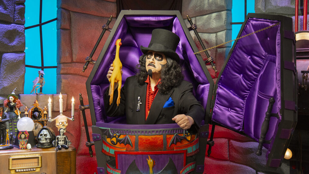Svengoolie with rubber chicken in coffing