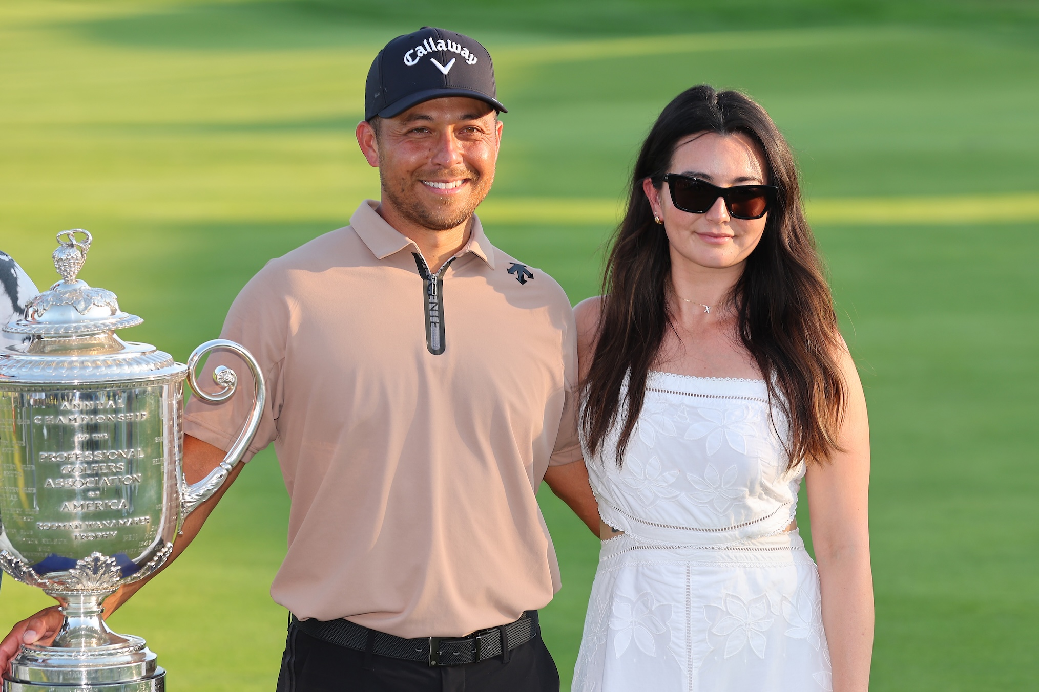 Xander Schauffele of the United States poses with his wife, Maya Schauffele, and the Wanamaker Trophy after winning the 2024 PGA Championship at Valhalla Golf Club on May 19, 2024 in Louisville, Kentucky.