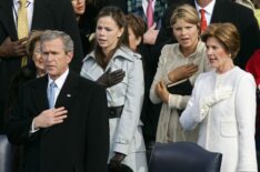 President George W. Bush (L) and his family, daughters Barbara (C), Jenna (2nd-R) and wife, first lady Laura Bush (R), hold their hands to their hearts during the playing of the national anthem before taking the oath of office for his second term during inaugural ceremonies on the west front of the U.S. Capitol January 20, 2005 in Washington, DC.