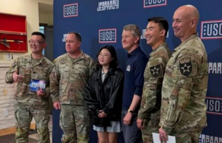 Ken Jennings posing with military members