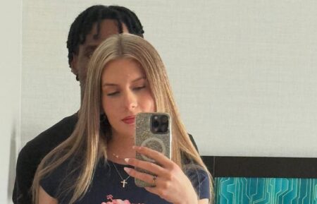 Teegan Nichols stands in front of new boyfriend, blocking his face from the camera.