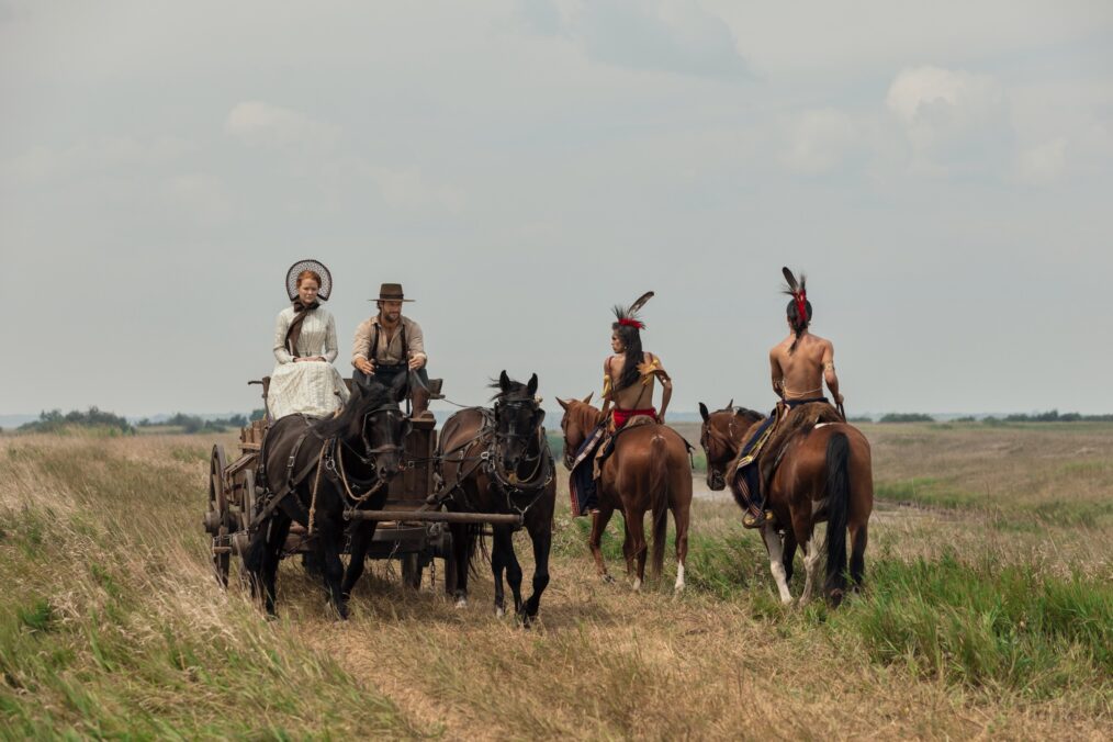 Little House on the Prairie. (L to R) Crosby Fitzgerald as Caroline Ingalls, Luke Bracey as Charles Ingalls, Corvin Mack as Myron, Xander Cole as Little Puma in episode 103 of Little House on the Prairie. Cr. Eric Zachanowich/Netflix © 2026