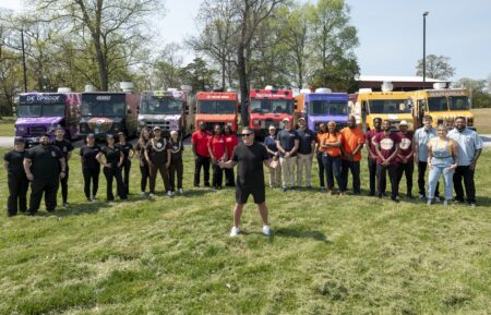 Host Tyler Florence with Deadproof Pizza Co., Grounds Donut House, Hele Rolls, Jollof Bowl, Bug & Bear’s Cannoli, Stuph’d Beignets & Burgers, Cason Funnel Cakes and Waffadilla team members, in front of their trucks, as seen on 'The Great Food Truck Race,' Season 19, Food Network, premieres July 26, 2026.