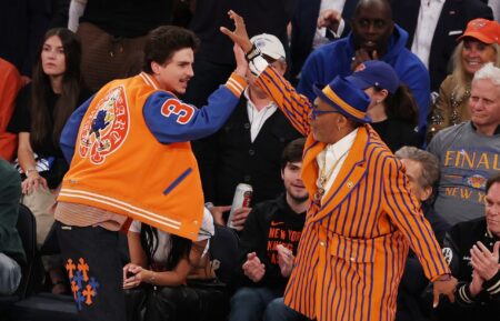 Miles Teller looks on as Timothee Chalamet and Spike Lee high five during the first quarter between the Indiana Pacers and the New York Knicks in Game Five of the Eastern Conference Finals of the 2025 NBA Playoffs at Madison Square Garden on May 29, 2025 in New York City.