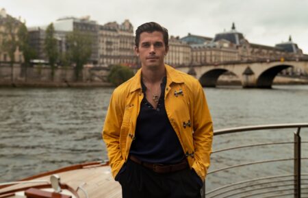 Antoni Porowski stands next to the Seine in Paris, France