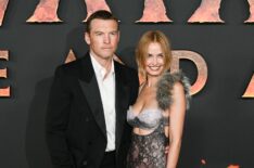 Australian actor Sam Worthington and his wife Australian model and businesswoman Lara Bingle pose during a photocall for the European premiere of 'Avatar: Fire and Ash' at the Seine Musicale concert hall in Boulogne-Billancourt, on the outskirts of Paris on December 5, 2025.