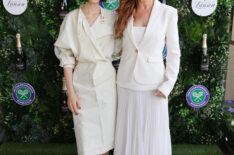Lily Collins (L) and Isla Fisher with Champagne Lanson at The Championships in Wimbledon at Agapanthus Suite on July 13, 2025 in Wimbledon, England